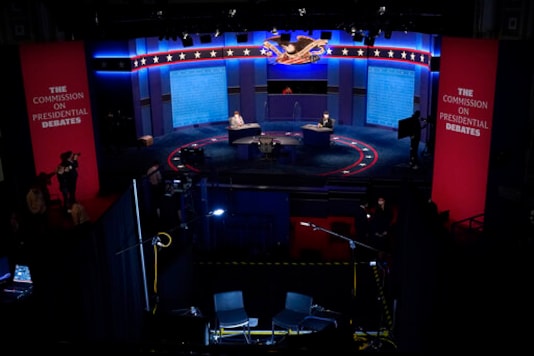 Members of the production crew stand in on the stage near plexiglass barriers which will serve as a way to protect the spread of COVID-19 as preparations take place for the vice presidential debate at the University of Utah, Tuesday, Oct. 6, 2020, in Salt Lake City. The vice presidential debate between Vice President Mike Pence and Democratic vice presidential candidate Sen. Kamala Harris, D-Calif., is scheduled for Oct. 7. (AP Photo/Julio Cortez) Members of the production crew stand in on the stage near plexiglass barriers which will serve as a way to protect the spread of COVID-19 as preparations take place for the vice presidential debate at the University of Utah, Tuesday, Oct. 6, 2020, in Salt Lake City. The vice presidential debate between Vice President Mike Pence and Democratic vice presidential candidate Sen. Kamala Harris, D-Calif., is scheduled for Oct. 7. (AP Photo/Julio Cortez)