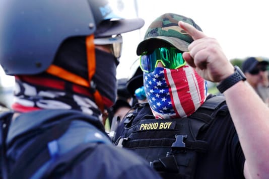 FILE - In this Sept. 26, 2020 file photo, a right-wing demonstrator gestures toward a counter protester as members of the Proud Boys and other right-wing demonstrators rally in Portland, Ore. President Donald Trump didn't condemn white supremacist groups and their role in violence in some American cities this summer. Instead, he said the violence is a left-wing FILE - In this Sept. 26, 2020 file photo, a right-wing demonstrator gestures toward a counter protester as members of the Proud Boys and other right-wing demonstrators rally in Portland, Ore. President Donald Trump didn't condemn white supremacist groups and their role in violence in some American cities this summer. Instead, he said the violence is a left-wing