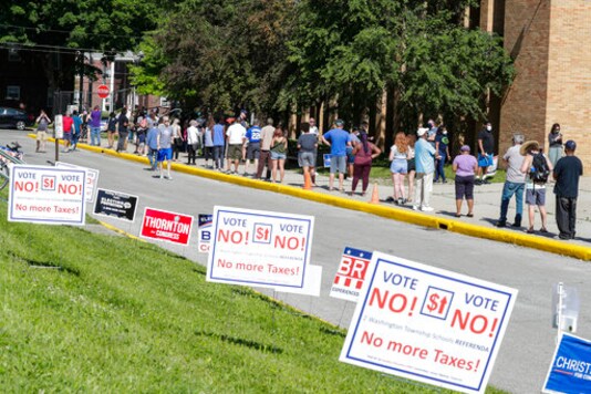 FILE - In this June 2, 2020 file photo, voters wait in a line outside Broad Ripple High School to vote in the Indiana primary in Indianapolis. Indiana election officials are bracing for perhaps 10 times more mail-in ballots for this fall's election than four years ago. The secretary of state office's projection of 1.3 million to 1.8 million mailed ballots means more than half of Indiana's voters might choose that option rather than heading to polling sites for the Nov. 3 election amid coronavirus exposure worries (AP Photo/Michael Conroy, File) FILE - In this June 2, 2020 file photo, voters wait in a line outside Broad Ripple High School to vote in the Indiana primary in Indianapolis. Indiana election officials are bracing for perhaps 10 times more mail-in ballots for this fall's election than four years ago. The secretary of state office's projection of 1.3 million to 1.8 million mailed ballots means more than half of Indiana's voters might choose that option rather than heading to polling sites for the Nov. 3 election amid coronavirus exposure worries (AP Photo/Michael Conroy, File)