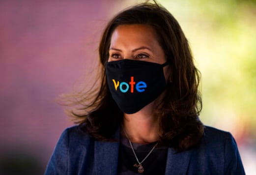 Michigan Gov. Gretchen Whitmer wears a mask with the word Michigan Gov. Gretchen Whitmer wears a mask with the word