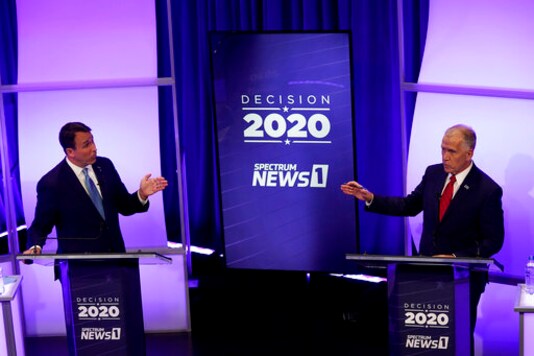 Democratic challenger Cal Cunningham, left, and U.S. Sen. Thom Tillis, R-N.C., talk during a televised debate Thursday, Oct. 1, 2020, in Raleigh, N.C. (AP Photo/Gerry Broome, Pool)