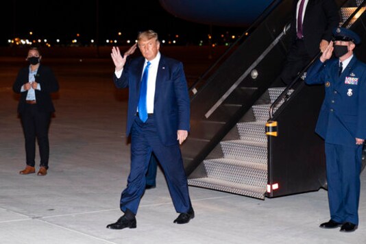 President Donald Trump waves as he steps off Air Force One at Las Vegas McCarran International Airport, Sunday, Oct. 18, 2020, in Las Vegas. (AP Photo/Alex Brandon) President Donald Trump waves as he steps off Air Force One at Las Vegas McCarran International Airport, Sunday, Oct. 18, 2020, in Las Vegas. (AP Photo/Alex Brandon)