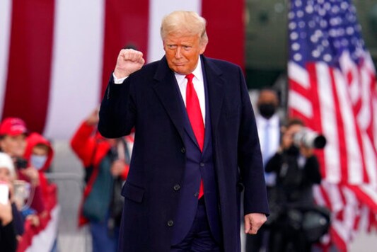 Supporters cheer as President Donald Trump arrives for a campaign rally at the Altoona-Blair County Airport in Martinsburg, Pa, Monday, Oct. 26, 2020. (AP Photo/Gene J. Puskar)