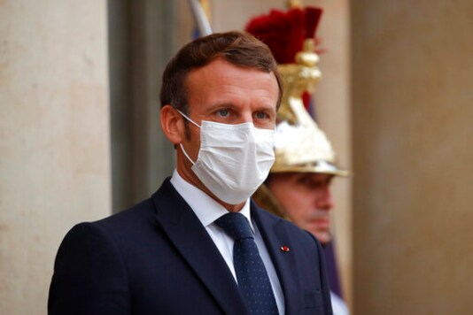 French President Emmanuel Macron, left, wearing a protective face mask, waits to welcome Armenian President Armen Sarkissian for a meeting at the Elysee Palace in Paris, Thursday, Oct. 22, 2020. (Charles Platiau/Pool via AP) French President Emmanuel Macron, left, wearing a protective face mask, waits to welcome Armenian President Armen Sarkissian for a meeting at the Elysee Palace in Paris, Thursday, Oct. 22, 2020. (Charles Platiau/Pool via AP)