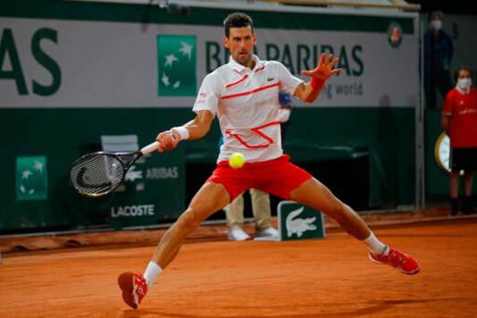 Serbia's Novak Djokovic plays a shot against Sweden's Mikael Ymer in the first round match of the French Open tennis tournament at the Roland Garros stadium in Paris, France, Tuesday, Sept. 29, 2020. (AP Photo/Michel Euler)