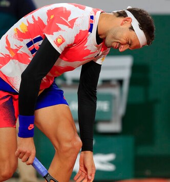 Bulgaria's Grigor Dimitrov reacts after missing a point in the fourth round match of the French Open tennis tournament against Greece's Stefanos Tsitsipas at the Roland Garros stadium in Paris, France, Monday, Oct. 5, 2020. (AP Photo/Michel Euler)