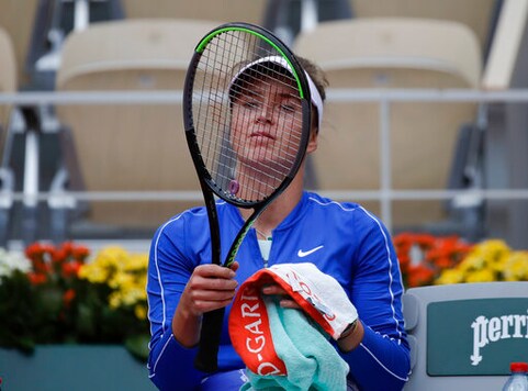 Ukraine's Elina Svitolina looks at her racket in the quarterfinal match of the French Open tennis tournament against Argentina's Nadia Podoroska at the Roland Garros stadium in Paris, France, Tuesday, Oct. 6, 2020. (AP Photo/Alessandra Tarantino)