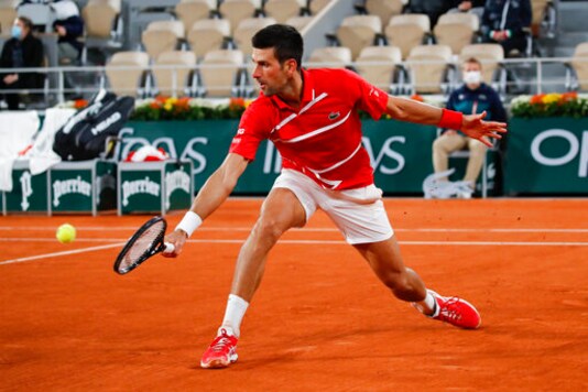 Serbia's Novak Djokovic plays a shot against Russia's Karen Khachanov in the fourth round match of the French Open tennis tournament at the Roland Garros stadium in Paris, France, Monday, Oct. 5, 2020. (AP Photo/Christophe Ena)