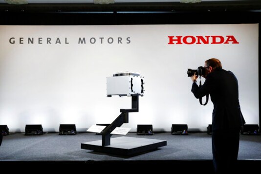 FILE -In this Jan. 30, 2020 file photo, a photographer captures images of the General Motors-Honda Next Generation Fuel Cell after a news conference in Detroit. On Thursday, Sept. 3, General Motors and Honda say they have signed a deal to explore sharing vehicle underpinnings and propulsion systems in North America. The companies say planning discussions on jointly designed vehicles will start immediately and include vehicles powered by both electricity and internal combustion engines. (AP Photo/Paul Sancya) FILE -In this Jan. 30, 2020 file photo, a photographer captures images of the General Motors-Honda Next Generation Fuel Cell after a news conference in Detroit. On Thursday, Sept. 3, General Motors and Honda say they have signed a deal to explore sharing vehicle underpinnings and propulsion systems in North America. The companies say planning discussions on jointly designed vehicles will start immediately and include vehicles powered by both electricity and internal combustion engines. (AP Photo/Paul Sancya)