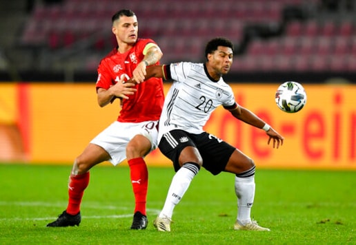 Germany's Serge Gnabry, right, and Switzerland's Granit Xhaka battle for the ball during the UEFA Nations League soccer match between Germany and Switzerland in Cologne, Germany, Tuesday, Oct. 13, 2020. (AP Photo/Martin Meissner) Germany's Serge Gnabry, right, and Switzerland's Granit Xhaka battle for the ball during the UEFA Nations League soccer match between Germany and Switzerland in Cologne, Germany, Tuesday, Oct. 13, 2020. (AP Photo/Martin Meissner)