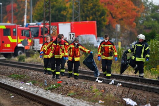 Rescue workers are on duty at the scene of a train accident in Bruckberg, Germany, Tuesday, Oct. 13, 2020. Two teenager brothers were hit and killed by a train in Bavaria on Tuesday as they apparently ran across the tracks in an attempt to make their own connection, police said. (Matthias Balk/dpa via AP) Rescue workers are on duty at the scene of a train accident in Bruckberg, Germany, Tuesday, Oct. 13, 2020. Two teenager brothers were hit and killed by a train in Bavaria on Tuesday as they apparently ran across the tracks in an attempt to make their own connection, police said. (Matthias Balk/dpa via AP)