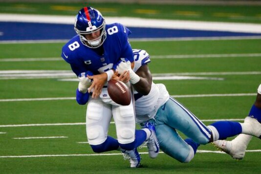 New York Giants quarterback Daniel Jones (8) fumbles the ball as he's sacked by Dallas Cowboys defensive end DeMarcus Lawrence (90) in the first half of an NFL football game in Arlington, Texas, Sunday, Oct. 11, 2020. (AP Photo/Michael Ainsworth) New York Giants quarterback Daniel Jones (8) fumbles the ball as he's sacked by Dallas Cowboys defensive end DeMarcus Lawrence (90) in the first half of an NFL football game in Arlington, Texas, Sunday, Oct. 11, 2020. (AP Photo/Michael Ainsworth)