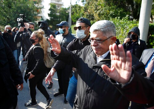 Golden Dawn party leader Nikos Michaloliakos waves as he leaves his residence in Athens, Thursday, Oct. 22, 2020.A court has sentenced Michaloliakos and the leadership of Greece's extreme-right Golden Dawn party to 13 years in prison, imposing the near-maximum penalty for running a criminal organization blamed for numerous violent hate crimes. The landmark ruling follows a five-year trial of dozens of top officials, members, and supporters of the organization founded as a Neo-Nazi group in the 1980s, that rose to become Greece's third-largest political party during a major financial crisis in the previous decade. (AP Photo/Thanassis Stavrakis)
