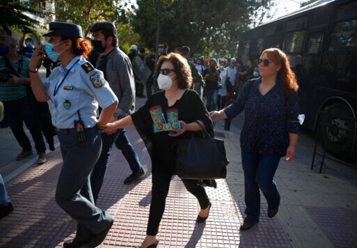 Magda Fyssa, center, the mother of late Greek rap singer Pavlos Fyssas, who was stabbed and killed by a supporter of the extreme right Golden Dawn party in 2013 triggering a crackdown on the party, is escorted into the court in Athens, Monday, Oct. 12, 2020. The court has extended to Monday a sentencing hearing for leading members and associates of Greece's far-right Golden Dawn convicted Oct. 7, 2020, of multiple crimes. (AP Photo/Thanassis Stavrakis) Magda Fyssa, center, the mother of late Greek rap singer Pavlos Fyssas, who was stabbed and killed by a supporter of the extreme right Golden Dawn party in 2013 triggering a crackdown on the party, is escorted into the court in Athens, Monday, Oct. 12, 2020. The court has extended to Monday a sentencing hearing for leading members and associates of Greece's far-right Golden Dawn convicted Oct. 7, 2020, of multiple crimes. (AP Photo/Thanassis Stavrakis)