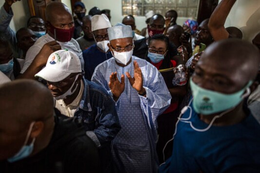 Guinean opposition leader Cellou Dalein Diallo, centre, walks with supporters at his headquarters in Conakry, Guinea, Monday Oct. 19, 2020. Diallo declared himself the winner after the country held an election on Sunday with Guinean President Alpha Conde seeking to extend his decade in power. (AP Photo/Sadak Souici) Guinean opposition leader Cellou Dalein Diallo, centre, walks with supporters at his headquarters in Conakry, Guinea, Monday Oct. 19, 2020. Diallo declared himself the winner after the country held an election on Sunday with Guinean President Alpha Conde seeking to extend his decade in power. (AP Photo/Sadak Souici)