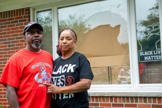 Eddie Hall Jr. and his wife Candace stand in front of the broken front window of their Warren, Mich., home, on Thursday, Sept. 10, 2020. An arrest has been made in connection with vandalism and shots fired into the couple's home. Warren Police Commissioner Bill Dwyer confirmed the arrest Tuesday night, Sept. 29 but didn't elaborate on charges or the person arrested. (David Guralnick/Detroit News via AP) Eddie Hall Jr. and his wife Candace stand in front of the broken front window of their Warren, Mich., home, on Thursday, Sept. 10, 2020. An arrest has been made in connection with vandalism and shots fired into the couple's home. Warren Police Commissioner Bill Dwyer confirmed the arrest Tuesday night, Sept. 29 but didn't elaborate on charges or the person arrested. (David Guralnick/Detroit News via AP)