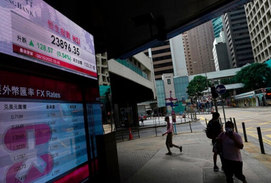 People walk past a bank's electronic board showing the Hong Kong share index at Hong Kong Stock Exchange Tuesday, Oct. 6, 2020. Shares advanced in on Tuesday Asia after hopes for economic aid from Washington helped Wall Street recover its losses from the initial shock of learning President Donald Trump had tested positive for the coronavirus. (AP Photo/Vincent Yu) People walk past a bank's electronic board showing the Hong Kong share index at Hong Kong Stock Exchange Tuesday, Oct. 6, 2020. Shares advanced in on Tuesday Asia after hopes for economic aid from Washington helped Wall Street recover its losses from the initial shock of learning President Donald Trump had tested positive for the coronavirus. (AP Photo/Vincent Yu)