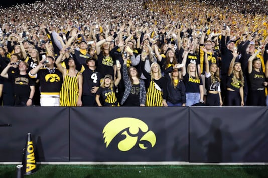 FILE - In this Saturday, Sept. 22, 2018 file photo, Iowa fans wave to children in the University of Iowa Stead Family Children's Hospital at the end of the first quarter of an NCAA college football game against Wisconsin in Iowa City, Iowa. During a season when the atmosphere will be subdued at Iowa home football games because the usual 69,000 fans won't be there, one tradition will go on uninterrupted. At the end of the first quarter, players and coaches from both teams will turn to the University of Iowa Stead Family Childrens Hospital and wave, just as they've done every home game since 2017.(AP Photo/Matthew Putney, File) FILE - In this Saturday, Sept. 22, 2018 file photo, Iowa fans wave to children in the University of Iowa Stead Family Children's Hospital at the end of the first quarter of an NCAA college football game against Wisconsin in Iowa City, Iowa. During a season when the atmosphere will be subdued at Iowa home football games because the usual 69,000 fans won't be there, one tradition will go on uninterrupted. At the end of the first quarter, players and coaches from both teams will turn to the University of Iowa Stead Family Childrens Hospital and wave, just as they've done every home game since 2017.(AP Photo/Matthew Putney, File)