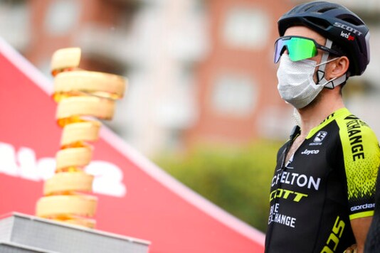 Britain's Simon Yates wears a face mask prior to the third stage of the Giro d'Italia cycling race from Enna to Etna, Monday Oct. 5, 2020. Overall contender Simon Yates has withdrawn from the Giro dItalia after testing positive for the coronavirus, his Mitchelton-Scott team announced before the eighth stage, Saturday, Oct. 10, 2020. (Marco Alpozzi/LaPresse via AP) Britain's Simon Yates wears a face mask prior to the third stage of the Giro d'Italia cycling race from Enna to Etna, Monday Oct. 5, 2020. Overall contender Simon Yates has withdrawn from the Giro dItalia after testing positive for the coronavirus, his Mitchelton-Scott team announced before the eighth stage, Saturday, Oct. 10, 2020. (Marco Alpozzi/LaPresse via AP)