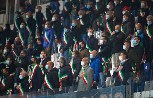 Mayors of the Bergamo province listen to the national anthem before the UEFA Nations League soccer match between Italy and the Netherlands at Azzurri d'Italia stadium in Bergamo, Italy, Wednesday, Oct. 14, 2020. (AP Photo/Antonio Calanni) Mayors of the Bergamo province listen to the national anthem before the UEFA Nations League soccer match between Italy and the Netherlands at Azzurri d'Italia stadium in Bergamo, Italy, Wednesday, Oct. 14, 2020. (AP Photo/Antonio Calanni)