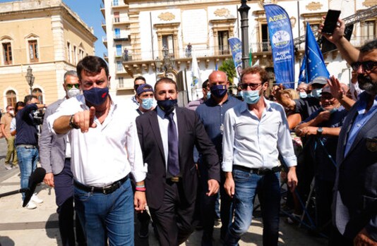 Former Interior Minister and Leader of League Party Matteo Salvini, left, arrives to attend a party rally in San Giovanni La Punta, near Catania, Sicily, Fridayday, Oct. 12, 2020. Salvini next Saturday, Oct. 3 will be attending a preliminary hearing in Catania for allegedly blocking 131 migrants on board of a coast guard ship from disembarking for 5 days in July 2019. (Mauro scrobogna/LaPresse via AP) Former Interior Minister and Leader of League Party Matteo Salvini, left, arrives to attend a party rally in San Giovanni La Punta, near Catania, Sicily, Fridayday, Oct. 12, 2020. Salvini next Saturday, Oct. 3 will be attending a preliminary hearing in Catania for allegedly blocking 131 migrants on board of a coast guard ship from disembarking for 5 days in July 2019. (Mauro scrobogna/LaPresse via AP)