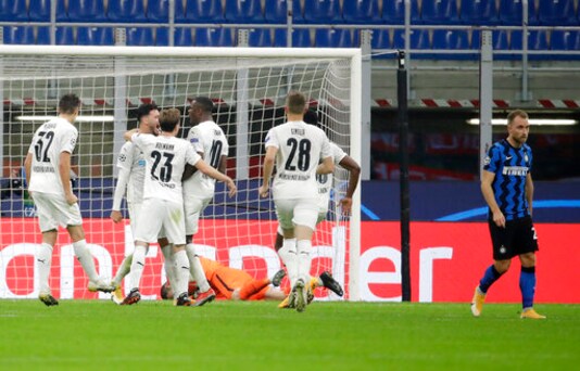 Moenchengladbach's Ramy Bensebaini, second from left, celebrates with his teammates after scoring his side's opening goal during the Champions League group B soccer match between Inter Milan and Borussia Moenchangladbach at the San Siro stadium in Milan, Italy, Wednesday, Oct. 21, 2020. (AP Photo/Luca Bruno) Moenchengladbach's Ramy Bensebaini, second from left, celebrates with his teammates after scoring his side's opening goal during the Champions League group B soccer match between Inter Milan and Borussia Moenchangladbach at the San Siro stadium in Milan, Italy, Wednesday, Oct. 21, 2020. (AP Photo/Luca Bruno)
