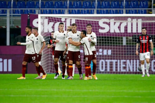 Roma's Edin Dzeko, center, celebrates after scoring his side's opening goal during the Serie A soccer match between AC Milan and Roma at the Milan San Siro Stadium, Italy, Monday, Oct. 26, 2020. (AP Photo/Luca Bruno) Roma's Edin Dzeko, center, celebrates after scoring his side's opening goal during the Serie A soccer match between AC Milan and Roma at the Milan San Siro Stadium, Italy, Monday, Oct. 26, 2020. (AP Photo/Luca Bruno)