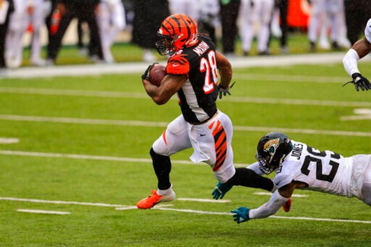 Cincinnati Bengals running back Joe Mixon (28) runs for a touchdown in front of Jacksonville Jaguars strong safety Josh Jones (29) in the second half of an NFL football game in Cincinnati, Sunday, Oct. 4, 2020. (AP Photo/Aaron Doster) Cincinnati Bengals running back Joe Mixon (28) runs for a touchdown in front of Jacksonville Jaguars strong safety Josh Jones (29) in the second half of an NFL football game in Cincinnati, Sunday, Oct. 4, 2020. (AP Photo/Aaron Doster)