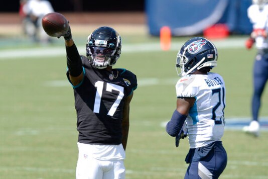 Jacksonville Jaguars wide receiver D.J. Chark (17) signals a first down after a reception against Tennessee Titans cornerback Malcolm Butler (21) in the first half of an NFL football game Sunday, Sept. 20, 2020, in Nashville, Tenn. (AP Photo/Mark Zaleski)