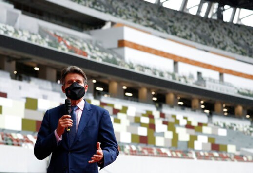 World Athletics President Sebastian Coe wearing a protective face mask speaks to media as he inspects at the National Stadium, the main stadium of Tokyo 2020 Olympics and Paralympics, in Tokyo Thursday, Oct. 8, 2020. (Issei Kato/Pool Photo via AP)