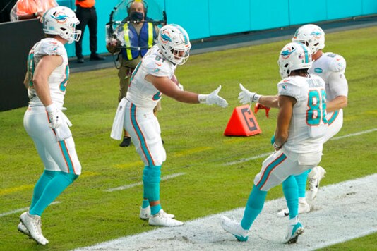 Miami Dolphins tight end Durham Smythe (81) is congratulated by wide receiver Mack Hollins (86) after Smythe scored a touchdown, during the first half of an NFL football game against the New York Jets, Sunday, Oct. 18, 2020, in Miami Gardens, Fla. (AP Photo/Wilfredo Lee) Miami Dolphins tight end Durham Smythe (81) is congratulated by wide receiver Mack Hollins (86) after Smythe scored a touchdown, during the first half of an NFL football game against the New York Jets, Sunday, Oct. 18, 2020, in Miami Gardens, Fla. (AP Photo/Wilfredo Lee)