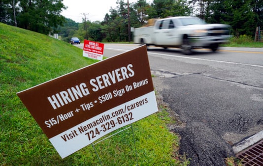 FILE - In this Wednesday, Sept. 2, 2020, file photo help wanted signs for servers and cooks at Nemacolin Woodlands Resort and Spa are displayed along route 40 at the entrance to the resort in Farmington, Pa. U.S. employers advertised more jobs but hired fewer workers in July, sending mixed signals about a job market in the wake of the coronavirus outbreak. The Labor Department said Wednesday, Sept. 9, 2020, that the number of U.S. job postings on the last day of July rose to 6.6 million from 6 million at the end of June. (AP Photo/Gene J. Puskar, File) FILE - In this Wednesday, Sept. 2, 2020, file photo help wanted signs for servers and cooks at Nemacolin Woodlands Resort and Spa are displayed along route 40 at the entrance to the resort in Farmington, Pa. U.S. employers advertised more jobs but hired fewer workers in July, sending mixed signals about a job market in the wake of the coronavirus outbreak. The Labor Department said Wednesday, Sept. 9, 2020, that the number of U.S. job postings on the last day of July rose to 6.6 million from 6 million at the end of June. (AP Photo/Gene J. Puskar, File)