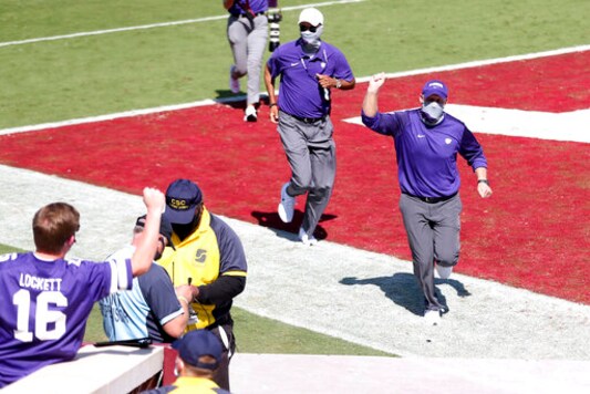 Kansas State head coach Chris Klieman pumps his fist while running off the field after his team's 38-35 win over the Oklahoma in an NCAA college football game, Saturday, Sept. 26, 2020, in Norman, Okla. (Ian Maule/Tulsa World via AP)