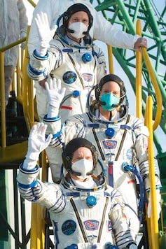 In this handout photo released by Roscosmos Space Agency, NASA's Kate Rubins, center, Sergey Ryzhikov and Sergey Kud-Sverchkov, top, of the Russian space agency wave before enter the Soyuz MS-17 for their trip to the International Space Station (ISS), at the Russian leased Baikonur cosmodrome, Kazakhstan, Wednesday, Oct. 14, 2020. A trio of space travelers has launched successfully to the International Spce Station, for the first time using a fast-track maneuver to reach the orbiting outpost in just three hours. (Andrey Shelepin/Roscosmos Space Agency via AP) In this handout photo released by Roscosmos Space Agency, NASA's Kate Rubins, center, Sergey Ryzhikov and Sergey Kud-Sverchkov, top, of the Russian space agency wave before enter the Soyuz MS-17 for their trip to the International Space Station (ISS), at the Russian leased Baikonur cosmodrome, Kazakhstan, Wednesday, Oct. 14, 2020. A trio of space travelers has launched successfully to the International Spce Station, for the first time using a fast-track maneuver to reach the orbiting outpost in just three hours. (Andrey Shelepin/Roscosmos Space Agency via AP)