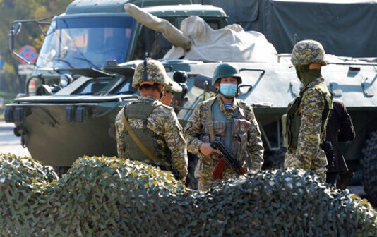 Kyrgyz army soldiers guard at a checkpoint on city street in Bishkek, Kyrgyzstan, Monday, Oct. 12, 2020. Kyrgyzstan's president on Monday ordered a new, week-long state of emergency in the country's capital after parliament failed to consider and approve his previous order within the legally required three days. (AP Photo/Vladimir Voronin) Kyrgyz army soldiers guard at a checkpoint on city street in Bishkek, Kyrgyzstan, Monday, Oct. 12, 2020. Kyrgyzstan's president on Monday ordered a new, week-long state of emergency in the country's capital after parliament failed to consider and approve his previous order within the legally required three days. (AP Photo/Vladimir Voronin)