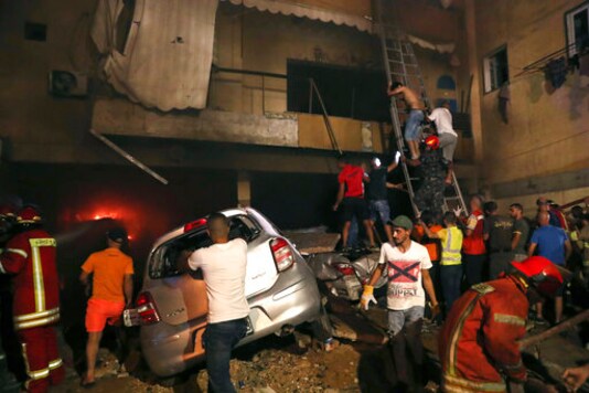 Firefighters extinguish a fire at a building after a diesel tank exploded in the neighborhood of Tarik al-Jadida, in Beirut, Lebanon, Friday, Oct. 9, 2020. (AP Photo/Bilal Hussein) Firefighters extinguish a fire at a building after a diesel tank exploded in the neighborhood of Tarik al-Jadida, in Beirut, Lebanon, Friday, Oct. 9, 2020. (AP Photo/Bilal Hussein)
