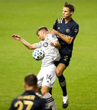 Jack Elliott, right, of the Philadelphia Union and Amar Sejdic of the Montreal Impact battle for the ball in the first half. The Philadelphia Union becomes the first Philadelphia-area team to allow fans in the stands for their game against Montreal Sunday, Oct. 11, 2020, in Chester, Pa. (Charles Fox/The Philadelphia Inquirer via AP) Jack Elliott, right, of the Philadelphia Union and Amar Sejdic of the Montreal Impact battle for the ball in the first half. The Philadelphia Union becomes the first Philadelphia-area team to allow fans in the stands for their game against Montreal Sunday, Oct. 11, 2020, in Chester, Pa. (Charles Fox/The Philadelphia Inquirer via AP)