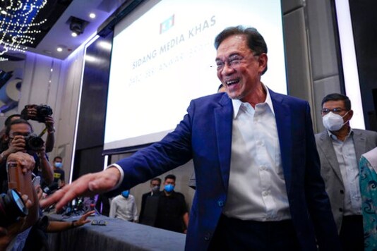 Malaysia's opposition leader Anwar Ibrahim gestures as he leaves after a press conference in Kuala Lumpur, Wednesday, Sept. 23, 2020. Anwar said he has secured a majority in parliament to form a new government that is strong, stable and formidable. Malaysia's opposition leader Anwar Ibrahim gestures as he leaves after a press conference in Kuala Lumpur, Wednesday, Sept. 23, 2020. Anwar said he has secured a majority in parliament to form a new government that is strong, stable and formidable.