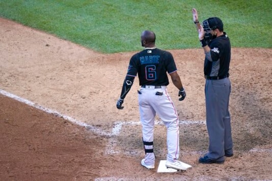 Miami Marlins' Starling Marte (6) looks to the mound after being hit by a pitch thrown by Chicago Cubs' Dan Winkler as umpire Pat Hoberg calls for an injury delay in the ninth inning of Game 1 of a National League wild-card baseball series in Chicago, Wednesday, Sept. 30, 2020. Marte left the game with an unknown injury. (AP Photo/Nam Y. Huh) Miami Marlins' Starling Marte (6) looks to the mound after being hit by a pitch thrown by Chicago Cubs' Dan Winkler as umpire Pat Hoberg calls for an injury delay in the ninth inning of Game 1 of a National League wild-card baseball series in Chicago, Wednesday, Sept. 30, 2020. Marte left the game with an unknown injury. (AP Photo/Nam Y. Huh)