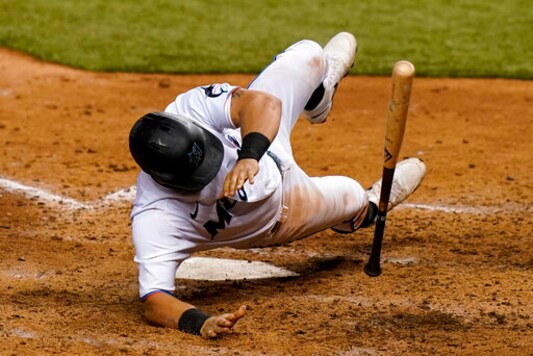 Miami Marlins' Francisco Cervelli (29) falls to the field on a close pitch thrown by New York Mets relief pitcher Dellin Betances during the eighth inning of a baseball game, Wednesday, Aug. 19, 2020, in Miami. (AP Photo/Lynne Sladky)