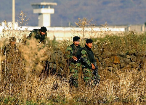 FILE - In this Jan. 28, 2005 file photo, Mexican Army soldiers inspect the surrounding the top-security Puente Grande prison, on the outskirts Guadalajara City, Mexico. The Mexican government announced Monday, Sept. 28, 2020, that it will close the Puente Grande federal prison made famous by the 2001 escape of convicted drug lord Joaquin FILE - In this Jan. 28, 2005 file photo, Mexican Army soldiers inspect the surrounding the top-security Puente Grande prison, on the outskirts Guadalajara City, Mexico. The Mexican government announced Monday, Sept. 28, 2020, that it will close the Puente Grande federal prison made famous by the 2001 escape of convicted drug lord Joaquin