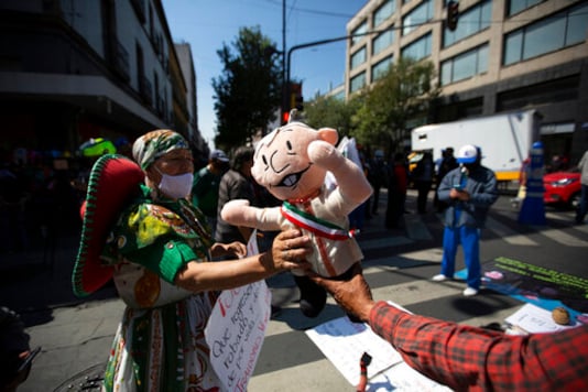A supporter of Mexico's President Andres Manuel Lopez Obrador holds a doll in his likeness during a demonstration outside of the Supreme Court in Mexico City, Thursday, Oct. 1, 2020. The court is scheduled to decide whether the president's proposal, to hold a popular vote on whether or not to pursue former presidents on corruption charges, stands up to scrutiny. (AP Photo/Fernando Llano) A supporter of Mexico's President Andres Manuel Lopez Obrador holds a doll in his likeness during a demonstration outside of the Supreme Court in Mexico City, Thursday, Oct. 1, 2020. The court is scheduled to decide whether the president's proposal, to hold a popular vote on whether or not to pursue former presidents on corruption charges, stands up to scrutiny. (AP Photo/Fernando Llano)