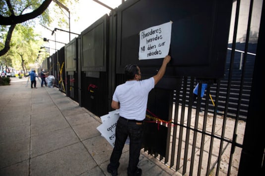 A Senate worker removes the Spanish message: A Senate worker removes the Spanish message: