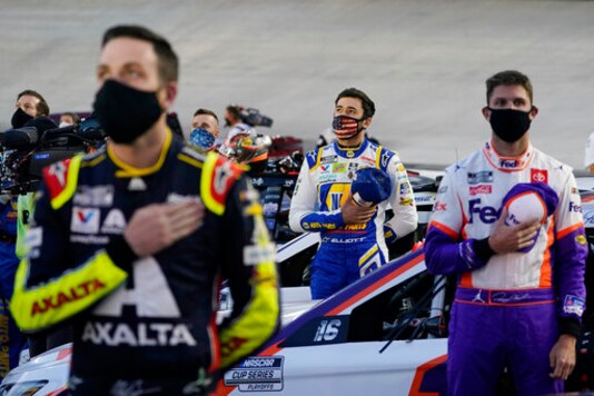 Alex Bowman, left, Chase Elliott, center, and Denny Hamlin listen to the national anthem before the NASCAR Cup Series auto race Saturday, Sept. 19, 2020, in Bristol, Tenn. (AP Photo/Steve Helber) Alex Bowman, left, Chase Elliott, center, and Denny Hamlin listen to the national anthem before the NASCAR Cup Series auto race Saturday, Sept. 19, 2020, in Bristol, Tenn. (AP Photo/Steve Helber)