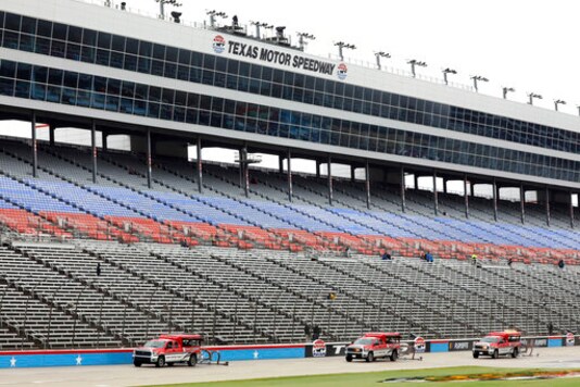 Drying trucks continue to prepare the track for a possible NASCAR Cup Series auto race at Texas Motor Speedway in Fort Worth, Texas, Tuesday, Oct. 27, 2020. The race was stopped on Sunday because of drizzle and misty conditions that allowed drivers to complete just 52 of 334 laps. Another 115 laps have to be completed to get to the halfway mark of 167 laps that would make Texas an official race. (AP Photo/Richard W. Rodriguez)