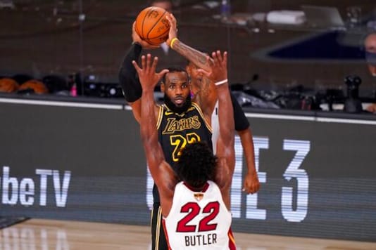 Los Angeles Lakers forward LeBron James (23) attempts to pass the ball under pressure from Miami Heat's Jimmy Butler (22) during the second half of Game 2 of basketball's NBA Finals, Friday, Oct. 2, 2020, in Lake Buena Vista, Fla. (AP Photo/Mark J. Terrill) Los Angeles Lakers forward LeBron James (23) attempts to pass the ball under pressure from Miami Heat's Jimmy Butler (22) during the second half of Game 2 of basketball's NBA Finals, Friday, Oct. 2, 2020, in Lake Buena Vista, Fla. (AP Photo/Mark J. Terrill)