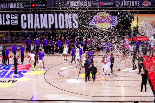 The Los Angeles Lakers players celebrate after the Lakers defeated the Miami Heat 106-93 in Game 6 of basketball's NBA Finals Sunday, Oct. 11, 2020, in Lake Buena Vista, Fla. (AP Photo/Mark J. Terrill)