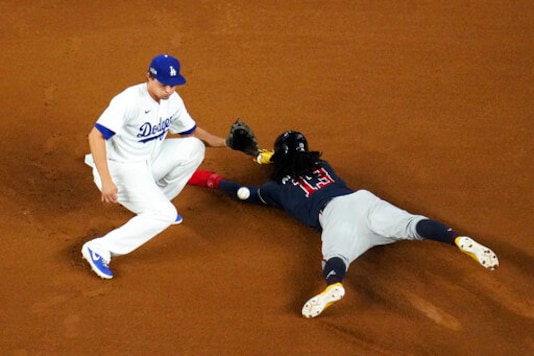 Atlanta Braves' Ronald Acuna Jr. is safe at second past Los Angeles Dodgers shortstop Corey Seager after a double during the first inning in Game 7 of a baseball National League Championship Series Sunday, Oct. 18, 2020, in Arlington, Texas. (AP Photo/David J. Phillip) Atlanta Braves' Ronald Acuna Jr. is safe at second past Los Angeles Dodgers shortstop Corey Seager after a double during the first inning in Game 7 of a baseball National League Championship Series Sunday, Oct. 18, 2020, in Arlington, Texas. (AP Photo/David J. Phillip)