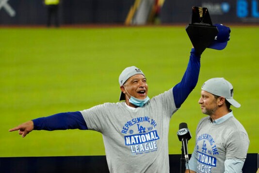 Los Angeles Dodgers manager Dave Roberts, left, and President of Baseball Operations Andrew Friedman celebrate with the trophy after winning Game 7 of a baseball National League Championship Series against the Atlanta Braves Sunday, Oct. 18, 2020, in Arlington, Texas. (AP Photo/Eric Gay) Los Angeles Dodgers manager Dave Roberts, left, and President of Baseball Operations Andrew Friedman celebrate with the trophy after winning Game 7 of a baseball National League Championship Series against the Atlanta Braves Sunday, Oct. 18, 2020, in Arlington, Texas. (AP Photo/Eric Gay)