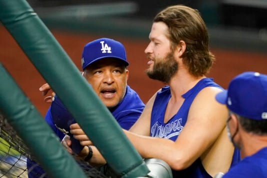 Los Angeles Dodgers manager Dave Roberts talks with starting pitcher Clayton Kershaw before Game 3 of a baseball National League Championship Series against the Atlanta Braves Wednesday, Oct. 14, 2020, in Arlington, Texas. (AP Photo/Tony Gutierrez) Los Angeles Dodgers manager Dave Roberts talks with starting pitcher Clayton Kershaw before Game 3 of a baseball National League Championship Series against the Atlanta Braves Wednesday, Oct. 14, 2020, in Arlington, Texas. (AP Photo/Tony Gutierrez)